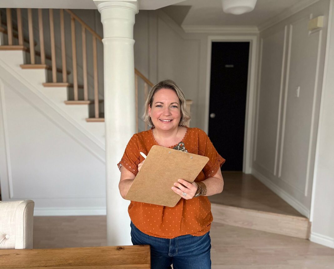 Shannon in an orange shirt with a clipboard for the decor staples checklist.